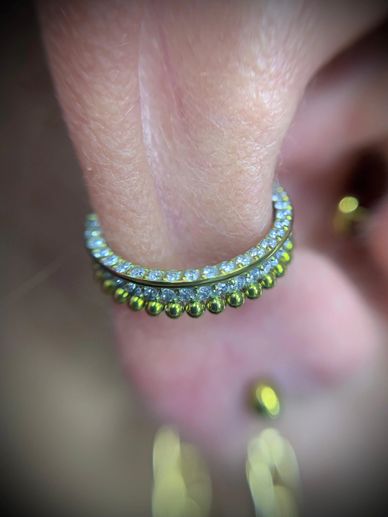 Gold and diamond-studded ring on a finger.