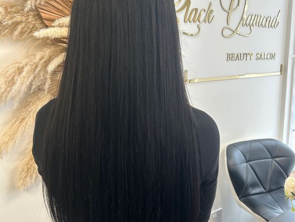 Long, sleek black hair in a beauty salon setting.