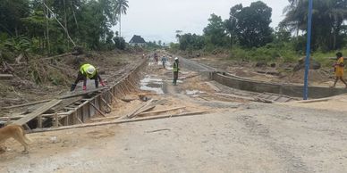 Construction workers building a concrete structure outdoors.