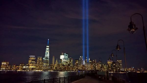 Night skyline with Twin Towers tribute lights.