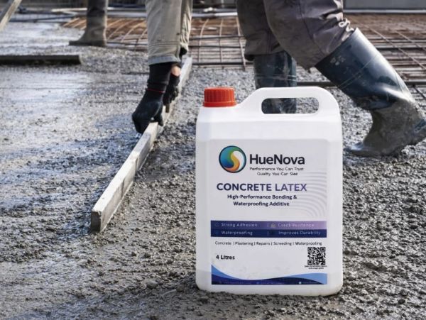 Container of HueNova Concrete Latex additive on wet concrete being leveled.