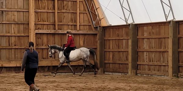 Coach Michelle teaching a student who is trotting.