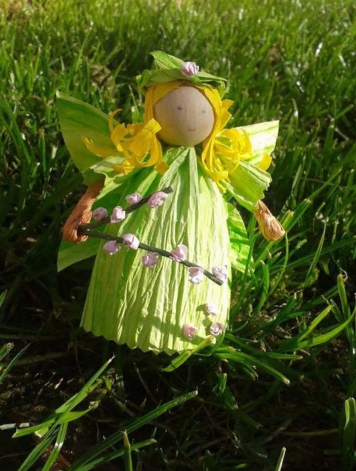 Handmade fairy doll with green dress and yellow hair.