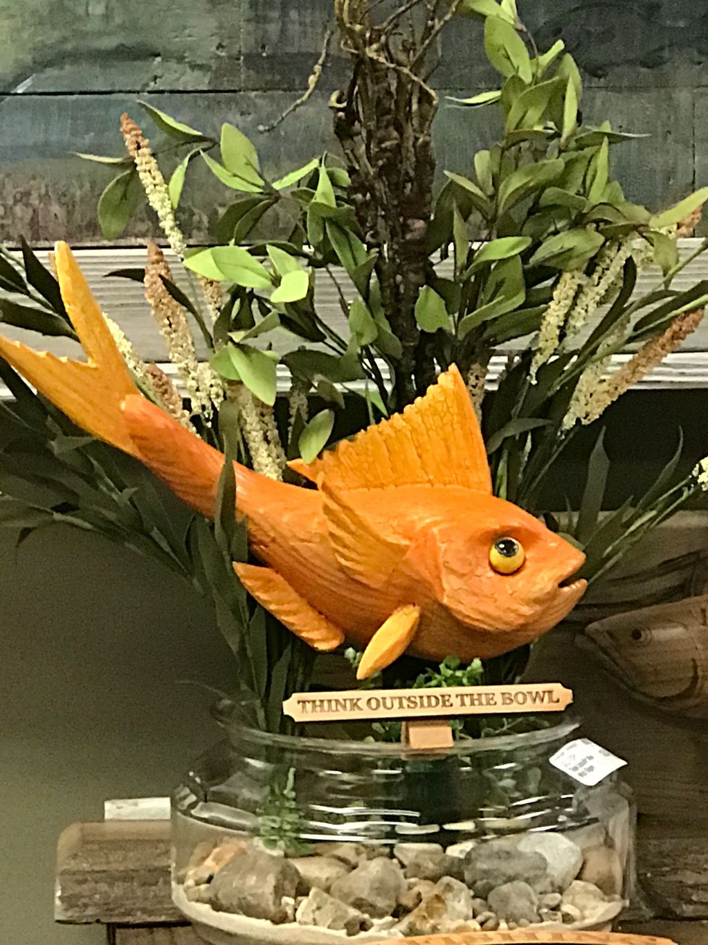 GOLD FISH HOVERING OVER A GOLDFISH BOWL