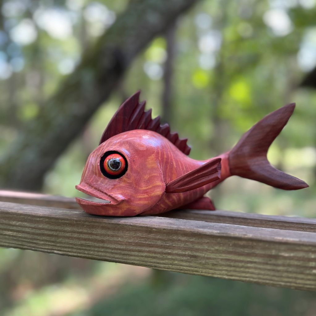Little red fish with Padauk exotic wood fins.  Wood red in color.  The body of the fish is cypress w