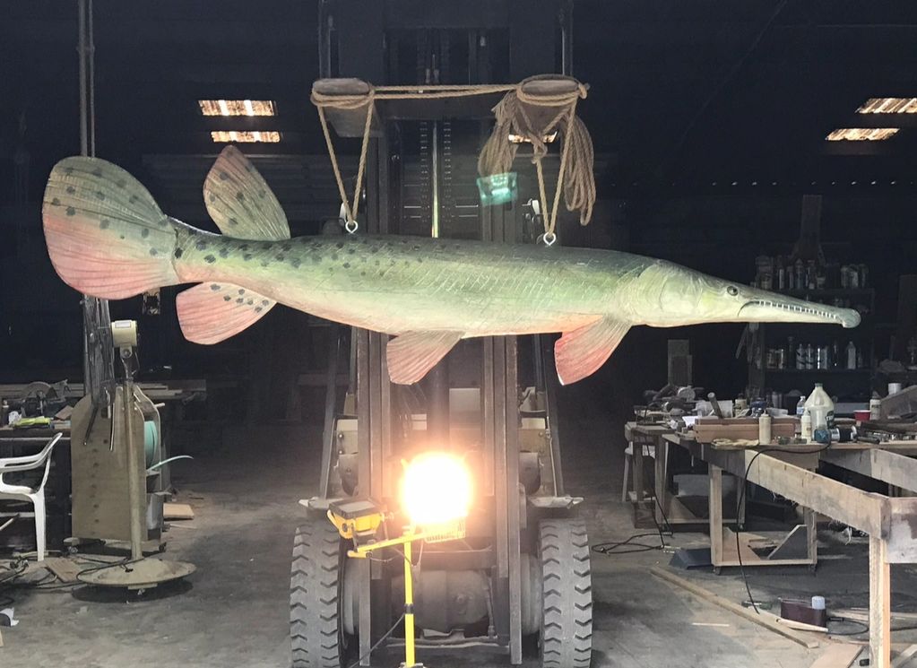 9 FOOT LONG TWO SIDED GAR FISH MADE FROM A CYPRESS LOG.