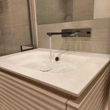Modern bathroom sink with running water.