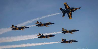 The Blue Angels flying in formation with one pilot breaking formation by TJ Waller Photography