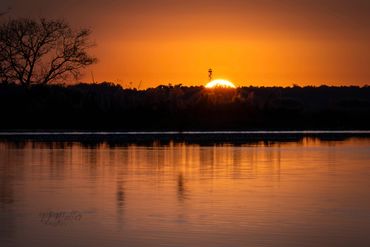 Beautiful sunrise on the St. Johns river with the sun coming up behind a fire tower