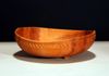 Made from Plum this 3 footed bowl has a bounty of colors. A hand carved band sits just below the rim. 8" x 1-3/4"
