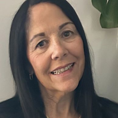 Smiling woman with long dark hair.
