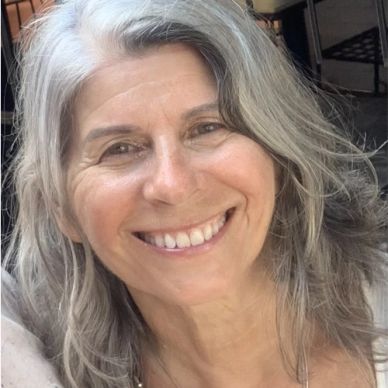 Smiling woman with gray hair close-up.