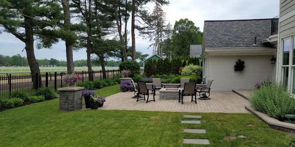 Well-maintained backyard patio with outdoor seating and greenery.