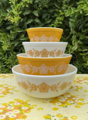 Stacked vintage mixing bowls with floral patterns.