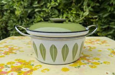 Vintage green and white pot with leaf pattern.