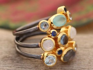 Multigemstone cocktail ring with 18k gold bezels and oxidized silver bands.