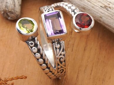 Sterling silver ring with amethyst, garnet, and peridot in polished harmony.