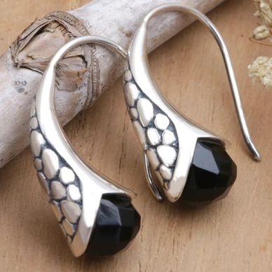 Sterling silver drop earrings with faceted onyx and intricate midnight-inspired detailing.