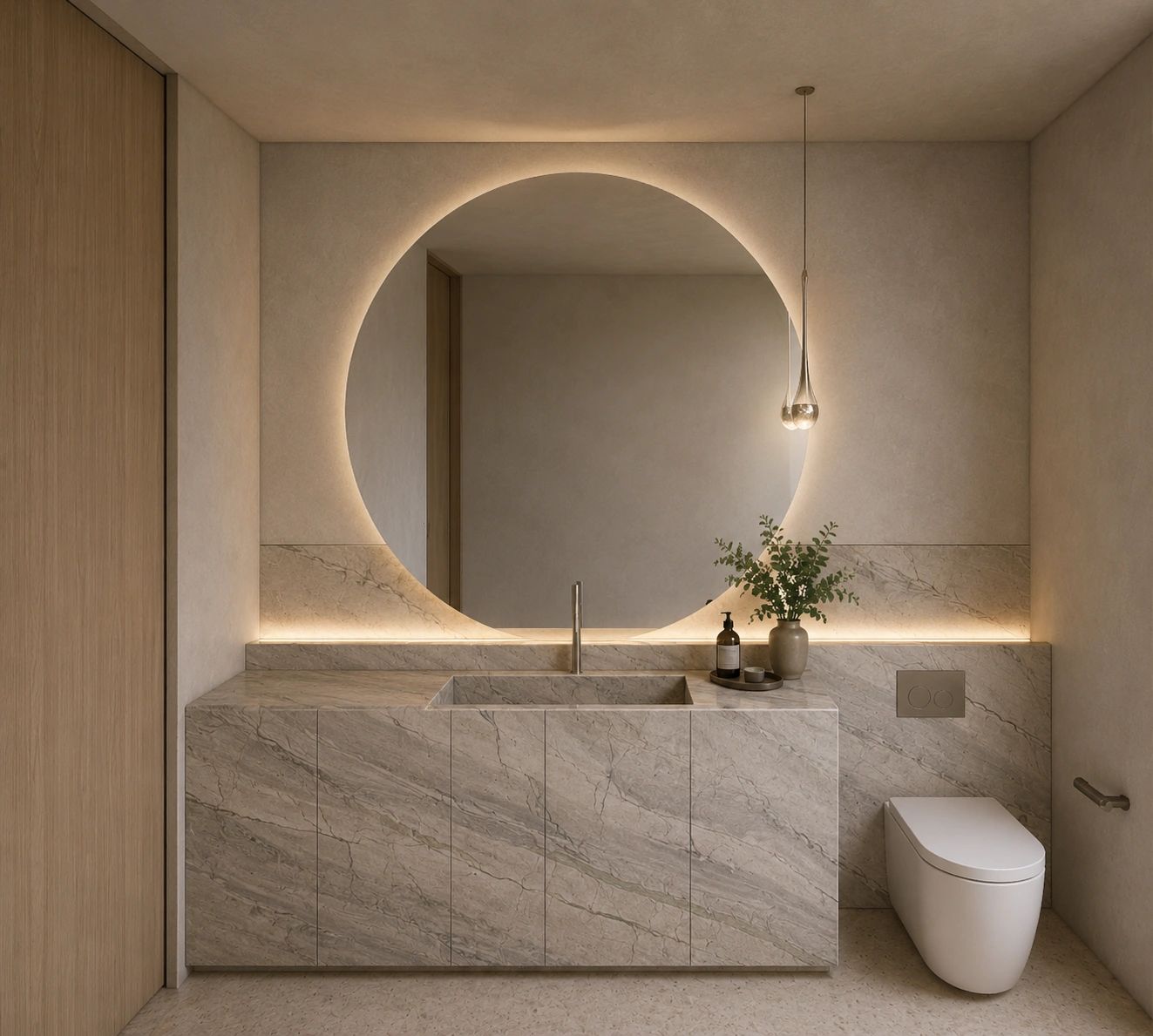 Minimalist bathroom with round backlit mirror and marble sink.