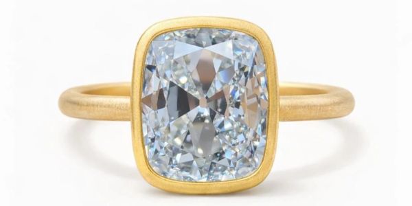 Elegant gold ring with a large cushion-cut diamond.