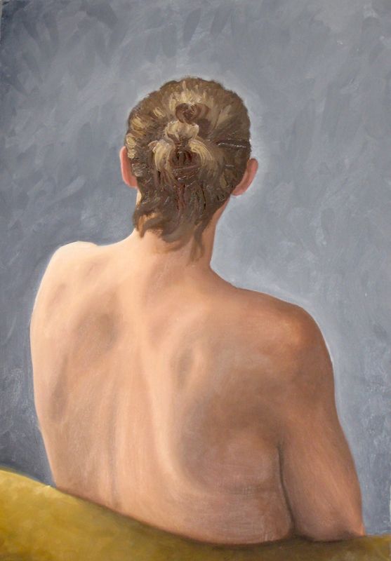 A woman sits with her back against the viewer turned slightly to the side, leaning back into a chair
