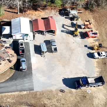 Aerial view of a small industrial yard with vehicles and equipment.
