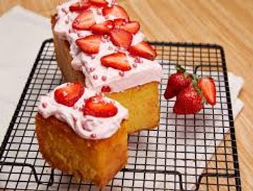 Sponge cake with strawberry frosting and sliced strawberries.