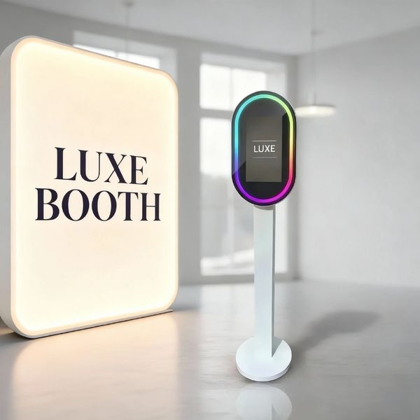 Modern Luxe Booth with sleek touchscreen and illuminated sign in bright room.