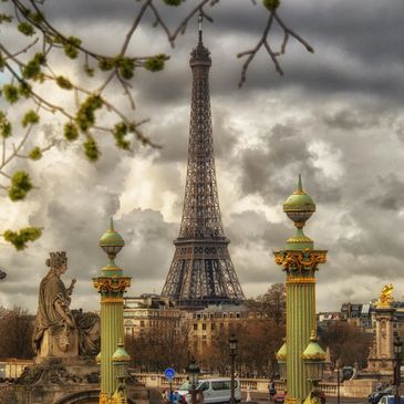 Eiffel Tower under a cloudy sky in Paris.