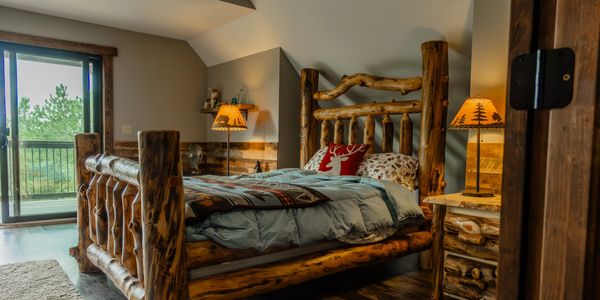 Rustic bedroom inside a secluded Wisconsin cabin retreat near Black River Falls