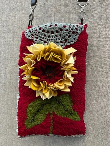 Handmade fabric pouch with a 3D sunflower design and crocheted flap.