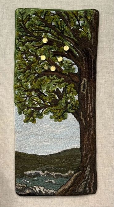 Embroidery of a large tree with golden fruits by a river under a cloudy sky.