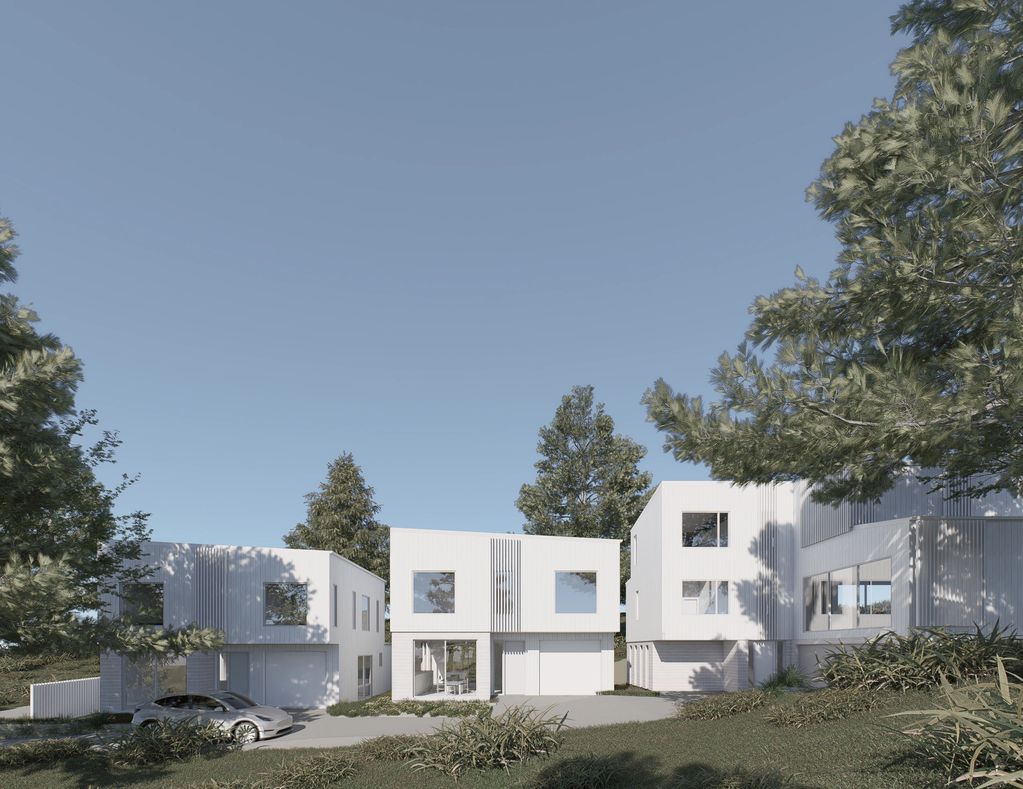 Modern white houses with large windows surrounded by trees under a clear sky.