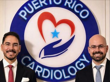 Two men in suits stand before a Puerto Rico Cardiology logo.