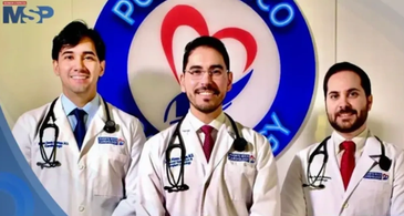 Three doctors in white coats standing in front of a health center emblem.