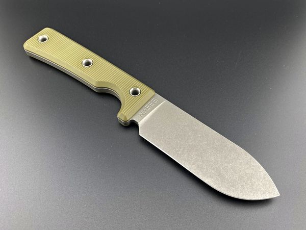 A sturdy knife with a textured beige handle on a dark surface.