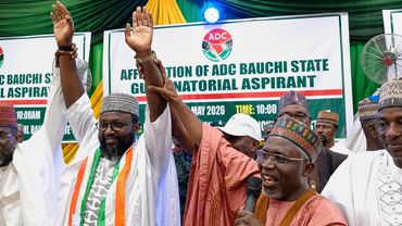 Group of men raising hands at an ADC Bauchi State event for gubernatorial aspirants.