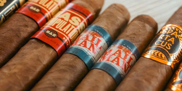 Close-up of several premium cigars with colorful bands.