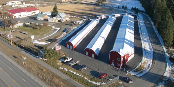 Aerial view of large red and white storage buildings.