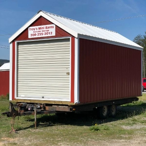 Mobile red mini barn on a trailer.