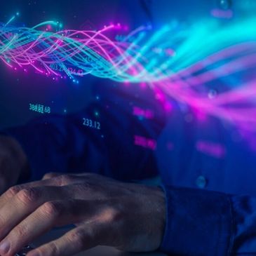 Hands interact with holographic data streams in futuristic technology.