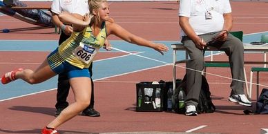 Girl throwing shot put 