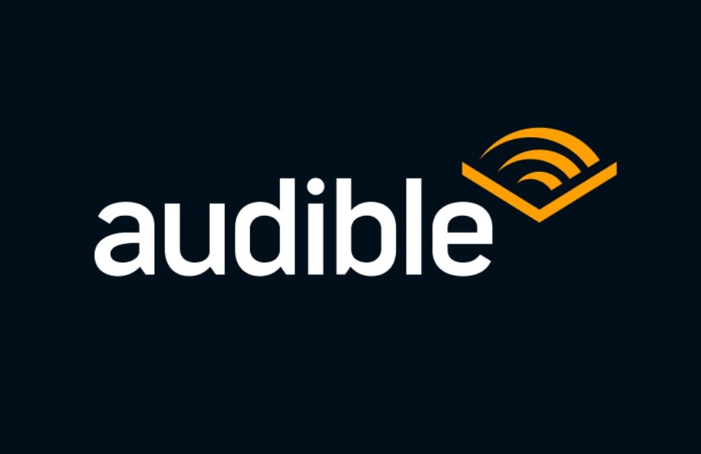 Audible logo with bold white text and an orange sound wave icon on dark background.
