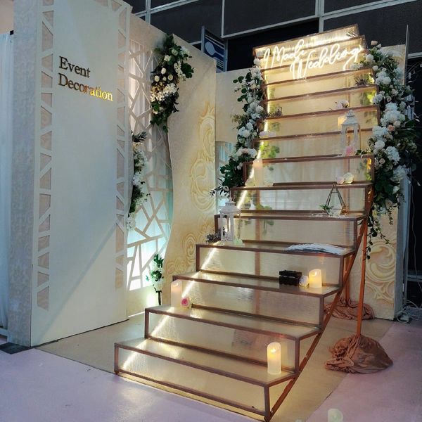 Elegant wedding-themed staircase decorated with flowers and candles.