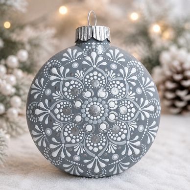 Decorative gray Christmas ornament with white intricate patterns.