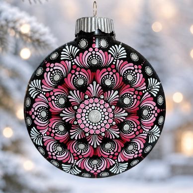 Black ornament with pink and white intricate design.