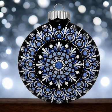 Decorative black Christmas ornament with blue and white patterns.