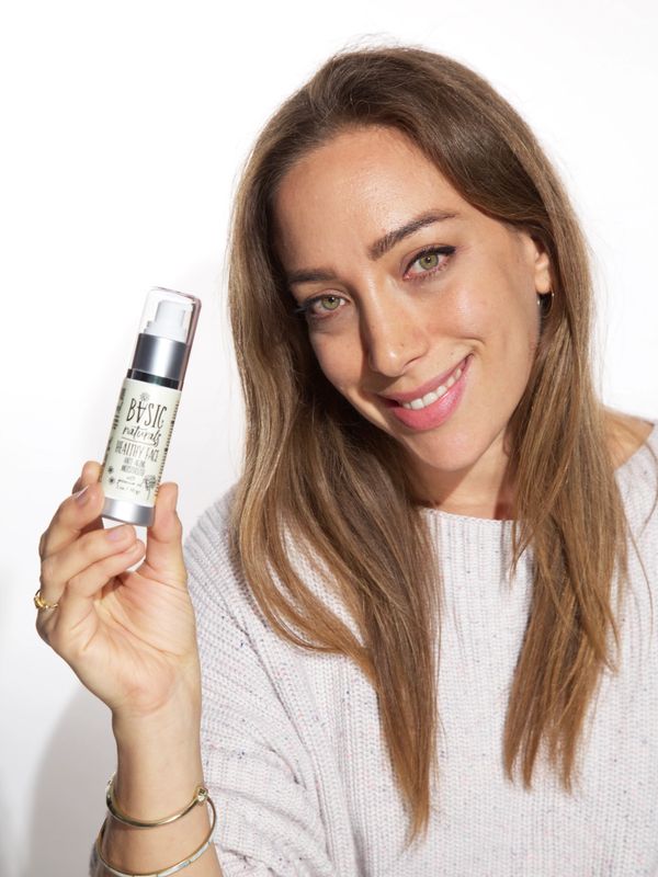 A woman holding anti aging moisturizer in her hand 