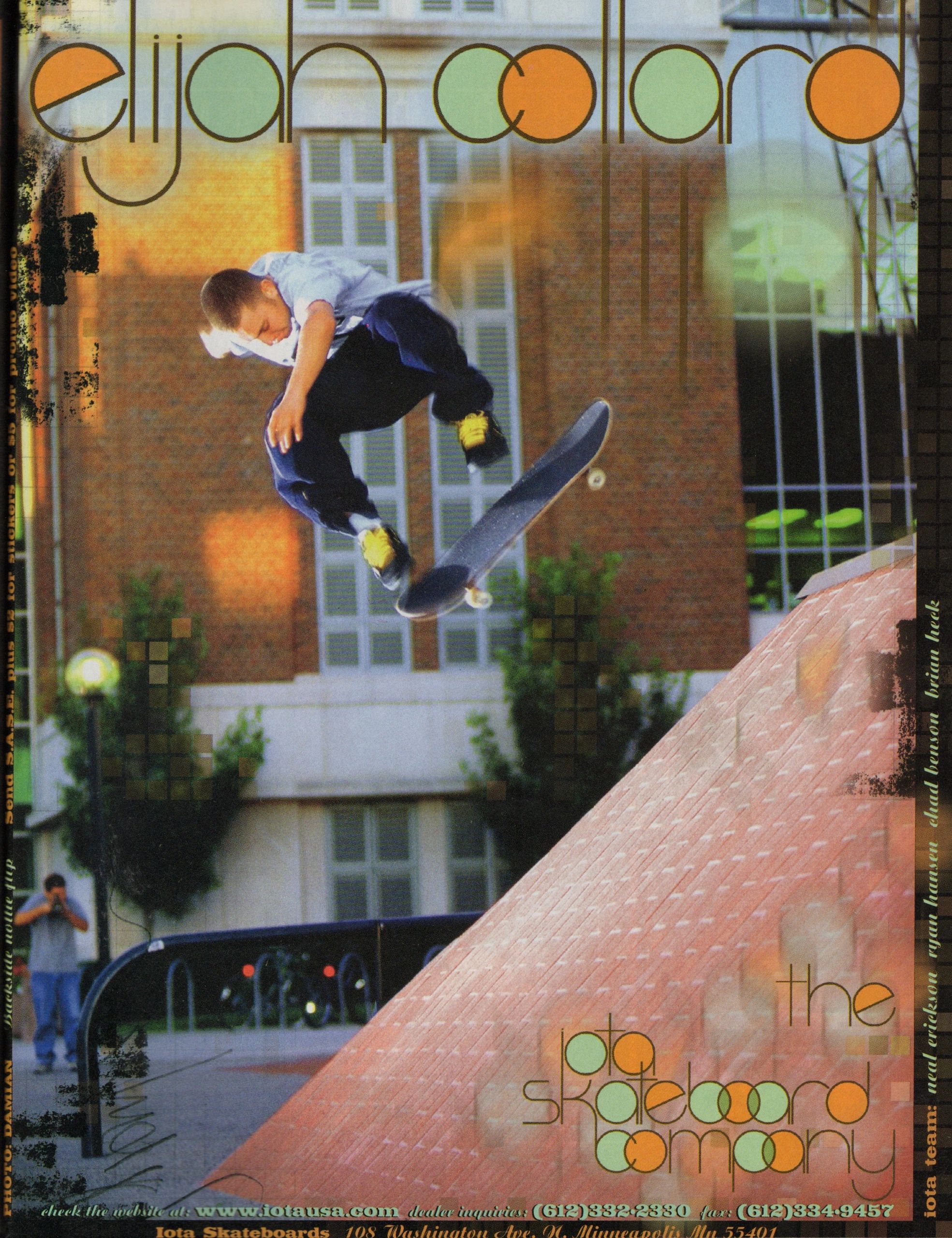 Skateboarder performing a trick on a ramp in an urban setting.