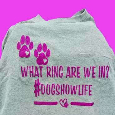 Gray shirt with purple paw prints and dog show text.